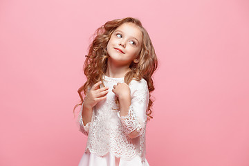 Image showing The beautiful little girl in dress standing and posing over white background