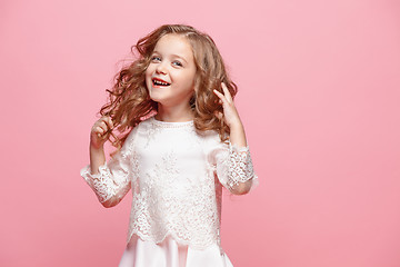 Image showing The beautiful little girl in dress standing and posing over white background