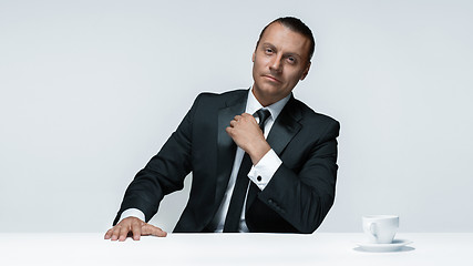 Image showing The attractive man in black suit on white background