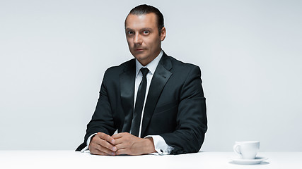 Image showing The attractive man in black suit on white background