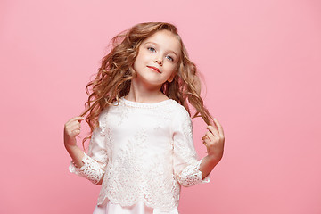 Image showing The beautiful little girl in dress standing and posing over white background