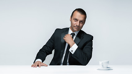 Image showing The attractive man in black suit on white background