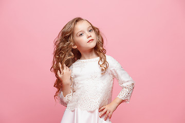 Image showing The beautiful little girl in dress standing and posing over white background