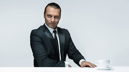 Image showing The attractive man in black suit on white background