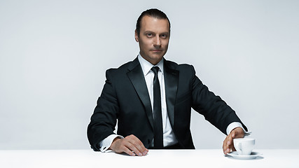 Image showing The attractive man in black suit on white background