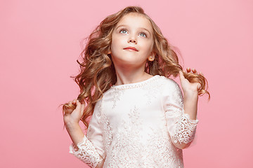 Image showing The beautiful little girl in dress standing and posing over white background