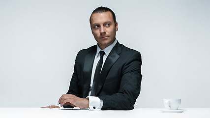 Image showing The attractive man in black suit on white background