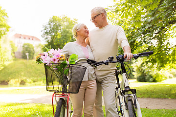 Image showing happy senior couple with bicycles at summer park