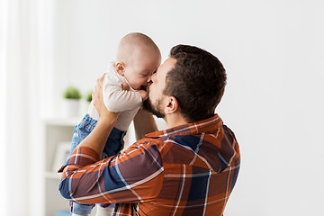 Image showing happy father kissing little baby boy at home