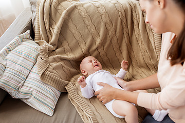 Image showing mother soothing crying little baby boy at home