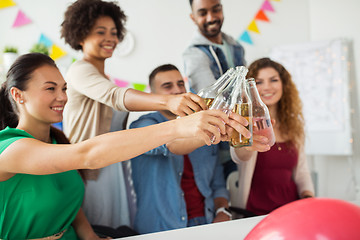 Image showing happy team with drinks celebrating at office party