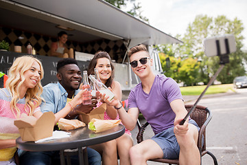 Image showing happy young friends taking selfie at food truck