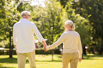 Image showing happy senior couple walking at summer park