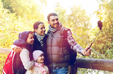 Image showing family with backpacks taking selfie and hiking