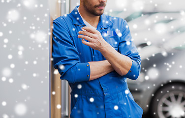 Image showing close up of auto mechanic smoking cigarette