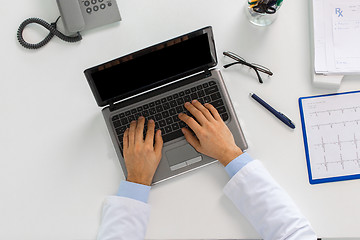 Image showing doctor hands typing on laptop at clinic