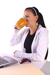 Image showing  Teenager Drinking Coffee While Working on the Computer