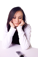 Image showing Beautiful Teenager Looking at her Phone Waiting for a Phone Call