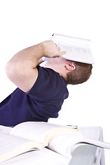 Image showing Tired College Student with Books on the Table Studying