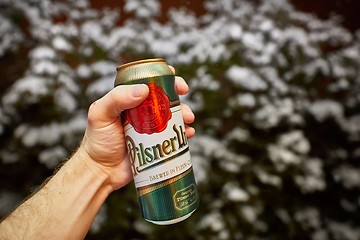 Image showing Holding beer in snowy weather