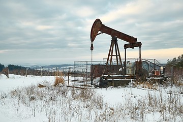 Image showing Oil well on a winter landscape