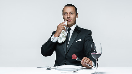 Image showing Bloody Halloween theme: crazy man with a knife, fork and meat