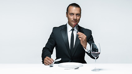 Image showing Bloody Halloween theme: crazy man with a knife, fork and meat