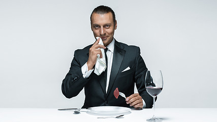 Image showing Bloody Halloween theme: crazy man with a knife, fork and meat