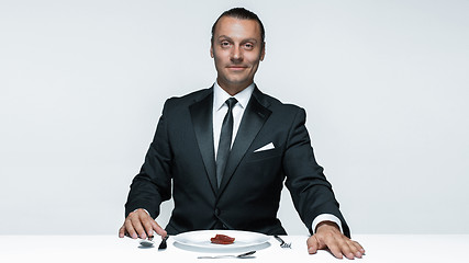 Image showing Bloody Halloween theme: crazy man with a knife, fork and meat