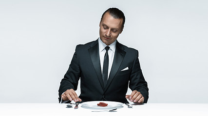 Image showing Bloody Halloween theme: crazy man with a knife, fork and meat