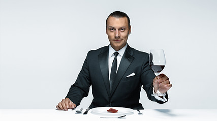 Image showing Bloody Halloween theme: crazy man with a knife, fork and meat