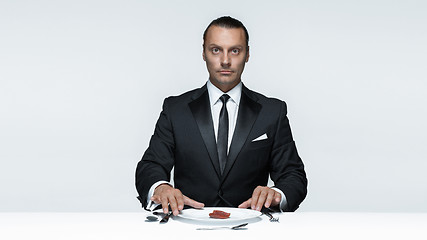 Image showing Bloody Halloween theme: crazy man with a knife, fork and meat