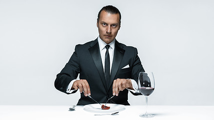 Image showing Bloody Halloween theme: crazy man with a knife, fork and meat