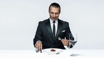 Image showing Bloody Halloween theme: crazy man with a knife, fork and meat