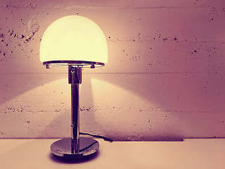 Image showing Lamp with round lampshade near concrete wall