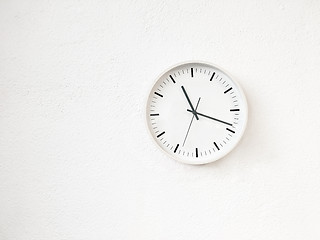 Image showing Simple modern round clock on white wall