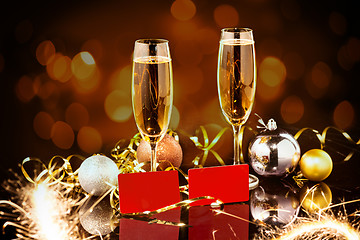 Image showing Christmas and New Year celebration with champagne. New Year holiday decorated table. Two Champagne Glasses