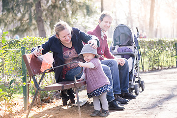 Image showing Young family with cheerful child in the park.