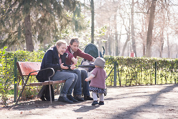 Image showing Family with child. First steps of the kid in the big world.