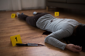 Image showing dead woman body lying on floor at crime scene