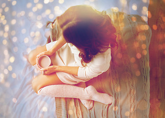 Image showing woman with cocoa cup in bed at home