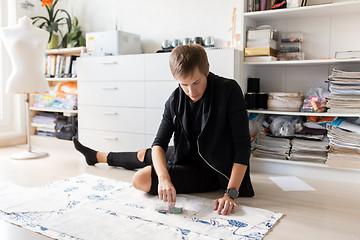 Image showing fashion designer with cloth making dress at studio