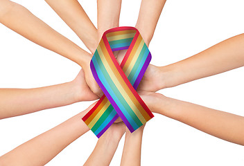 Image showing female hands holding gay pride awareness ribbon