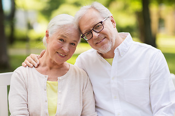 Image showing happy senior couple sitting on bench at park