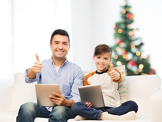 Image showing father and son with tablet pc showing thumbs up