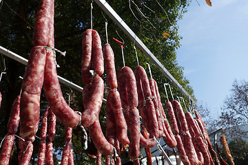 Image showing The suspended pieces of the meat drying outside