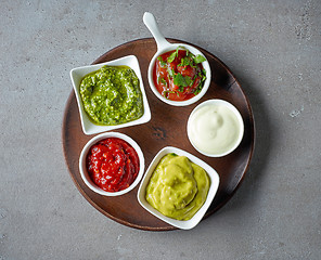 Image showing various sauces on grey table