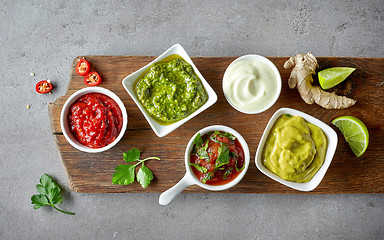 Image showing various sauces on grey table