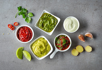 Image showing various sauces on grey table