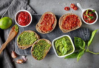 Image showing Bread slices with basil pesto and garlic tomato sauce